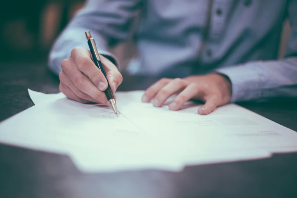 a person signing a document 
